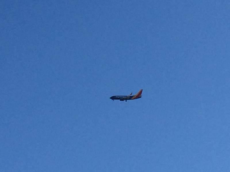 Illustration for article titled Working on a roof in line with the final approach path is great for plane spotting...